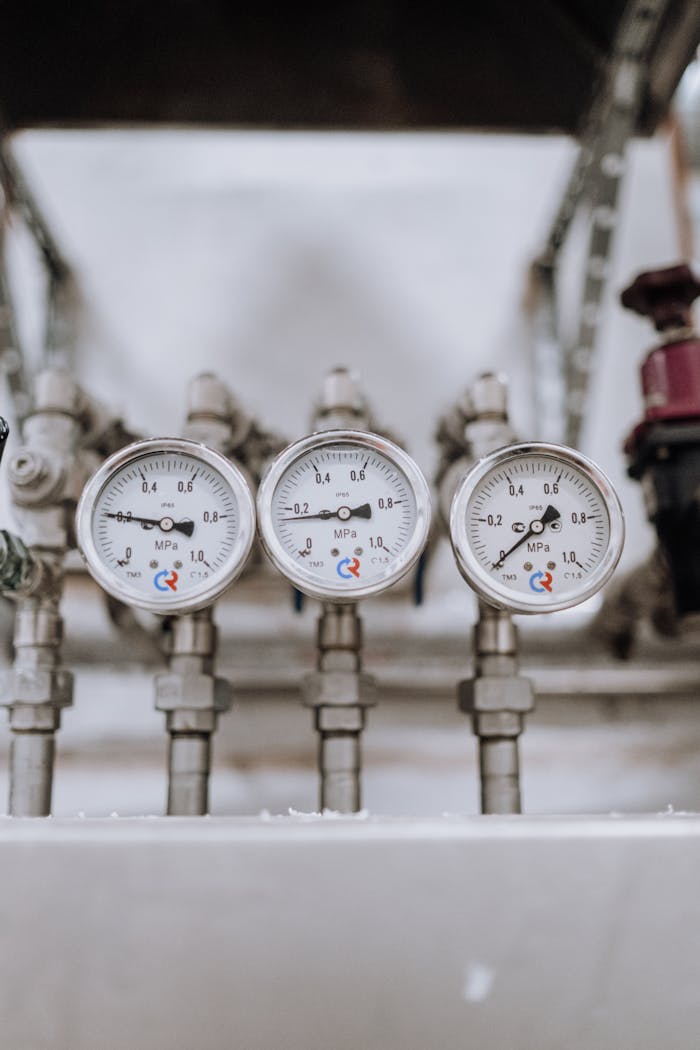 The Art of Drawing Readers In: Your attractive post title goes here Close-up of three industrial pressure gauges on pipelines indoors.